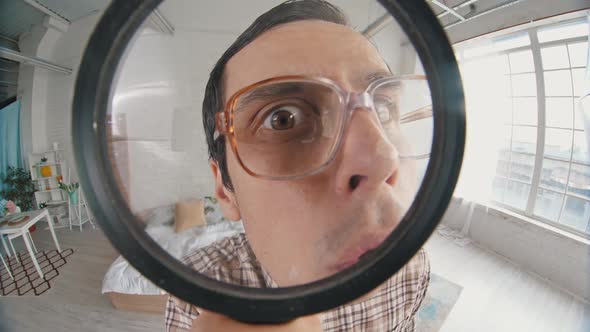 Nerd Looks Through Magnifier Glass