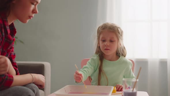 Girl Draws on Oily Water with Teacher at Ebru Masterclass