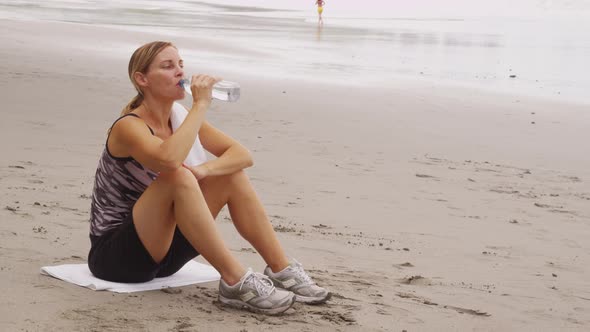 Woman drinking water after run. Shot on RED EPIC for high quality 4K, UHD, Ultra HD resolution.