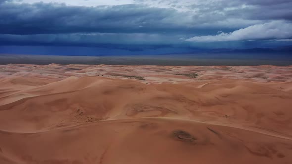 Sand Dunes with Storm Clouds in Gobi Desert