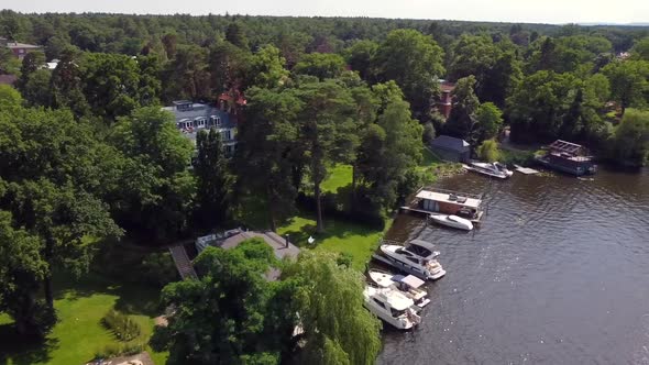 Gorgeous aerial drone flight panorama overview drone shot over a river with boats sun reflectionAer