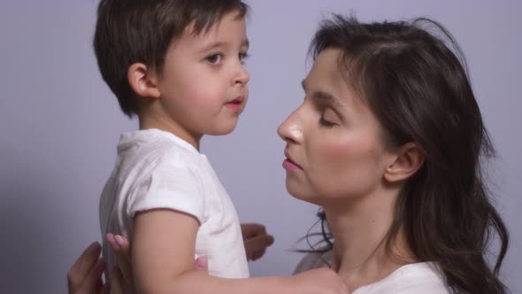 Mother and Son in White T-shirts on a White Background