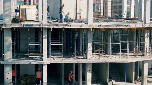 Builders Work at a Construction Site.