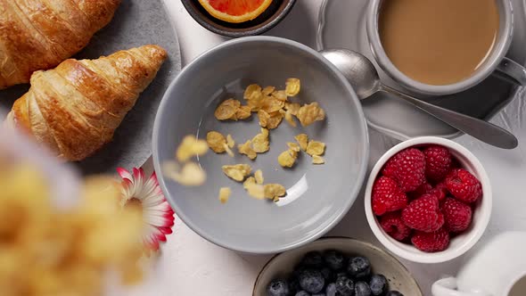 Pouring Cornflakes Into Breakfast Bowl