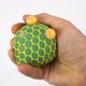 Man's hand squeezing stress ball on white. Squeezing green anti stress toy.  - VideoHive Item for Sale