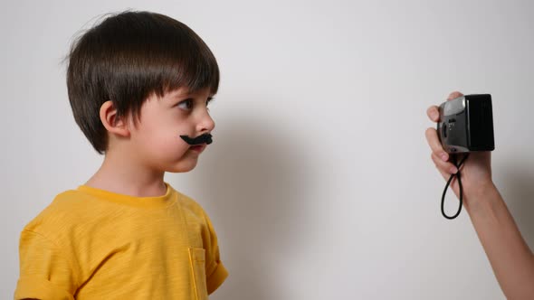 Girl in a Yellow T-shirt Photographs a Funny Boy