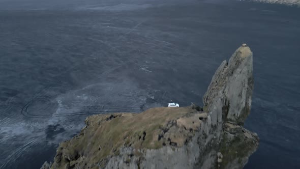 Beautiful Bird's Eye View Shot of Horizon with Tire Tracks and Sea Stack