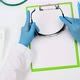 doctor in blue medical gloves and a white coat sits at a white table - VideoHive Item for Sale