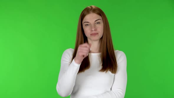 Portrait of Pretty Young Woman Is Listening Attentively and Nodding His Head Pointing Finger at