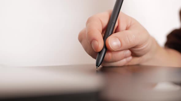 a Male Designer Works with Laptop on Graphics Tablet Photographer Photo Retouching and Processing