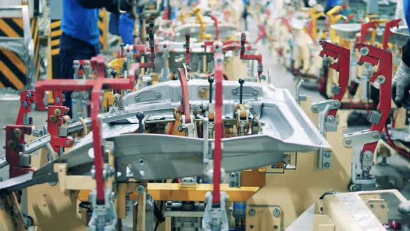 Car Manufacturing Worker Is Using a Machine at a Car Production Factory