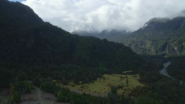 Dolly out aerial view of snow-capped mountains in Hornopiren National Park, Hualaihue, Chile