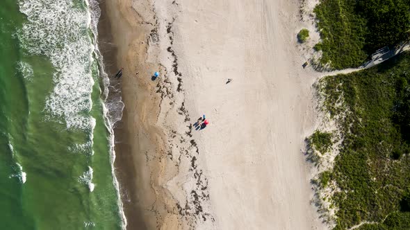 Aerial of Tourists on Vacation with Beach Umbrella in Cocoa, Florida