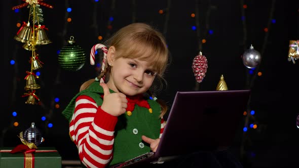 Kid Girl Christmas Elf Costume Doing Shopping Online Using Laptop Browsing Social Media