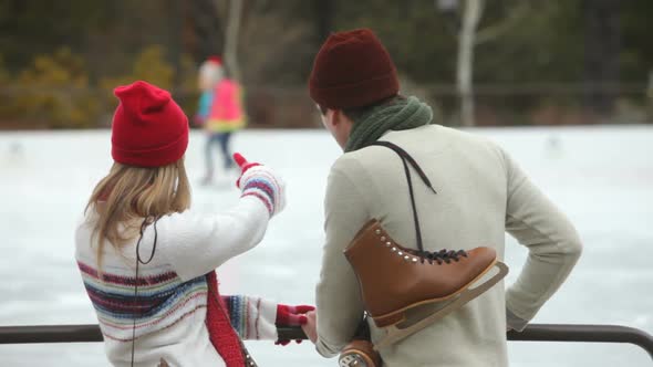 Couple together by ice skating rink