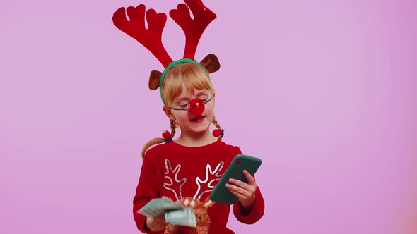 Girl in Red Christmas Deer Antlers Looking Smartphone Rejoicing Win Success Luck Receiving Money