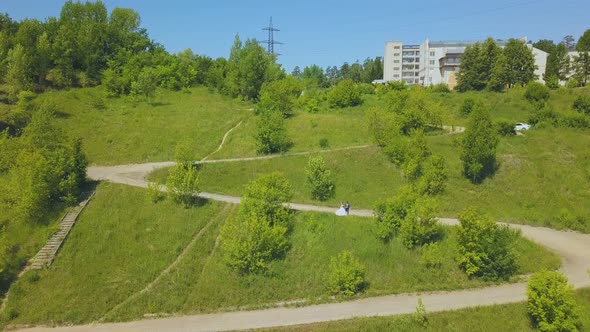 Distant Just Married Couple on Hill Curvy Road Bird Eye View