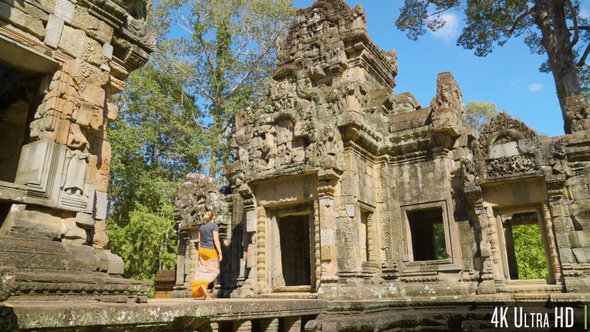 4K Young Woman Walking on Ancient Ruins Near Angkor Wat in Cambodia