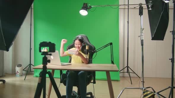 Kid Girl Playing Video Game With Mobile Phone Then Celebrating While Live Stream On Green Screen