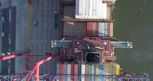 Aerial scene with drones. Container terminal of the port. Camera down with a view of ship and contai