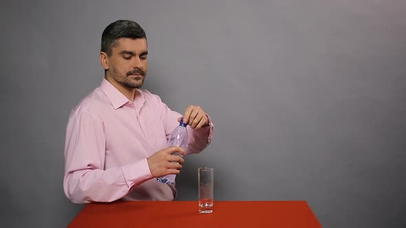 Male Pouring Mineral Water in Glass, Tasting and Showing Thumbs Up, Good Quality