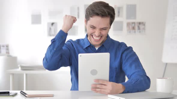 Casual Adult Man Excited for Results on Tablet