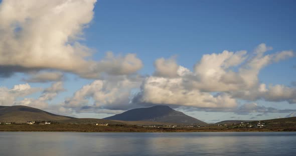 Time Lapse of clouds rolling over hills of a remote landscape on summer day in Ireland.