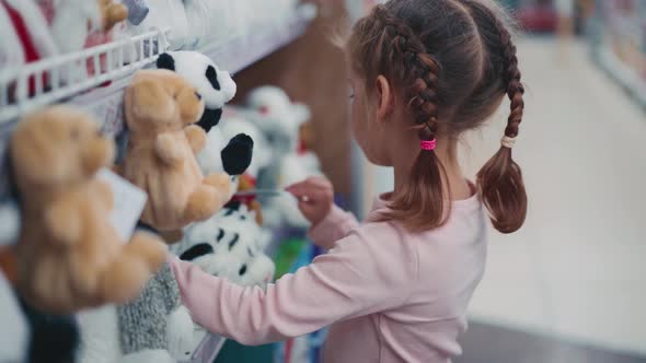 Little Child Asks His Mother to Buy White Tiger Soft Toy in Children's Department Store