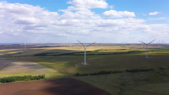 Aerial View Over the Farm Landscape and Wind Turbines Generating Clean Renewable Energy