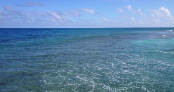 Tropical drone island view of a sandy white paradise beach and aqua blue ocean background 