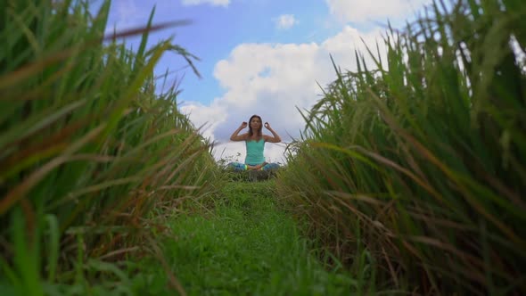 Slowmotion Steadicam Shot of a Young Woman Doing Meditation for Muladhara Chakra in a Balinese Way