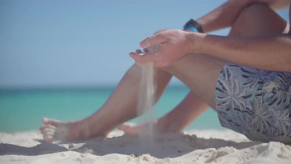 Hand Playing With Sand On Bahamas Vacation Holiday. Man Pouring Sand Through Fingers.Caribbean Coast
