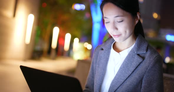 Businesswoman use of notebook computer at night