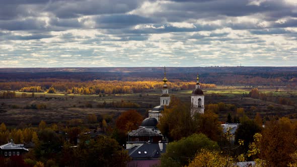 Aerial View of Christian Church in Front of Golden Autumn Forest And Cloudy Sky