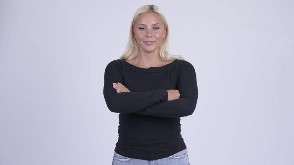 Young Happy Blonde Woman Smiling with Arms Crossed