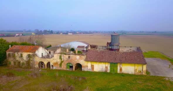 Abandoned Farm House Among Fields and Trees Near Small Town