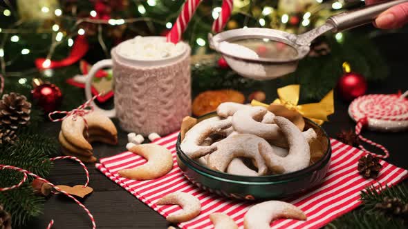 Woman Sprinkles Sugar Powder on Traditional German or Austrian Vanillekipferl Vanilla Kipferl