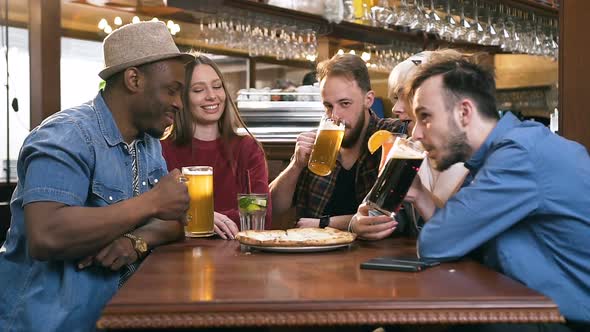 Five Young Attractive Friends Chatting in the Bar, Pub