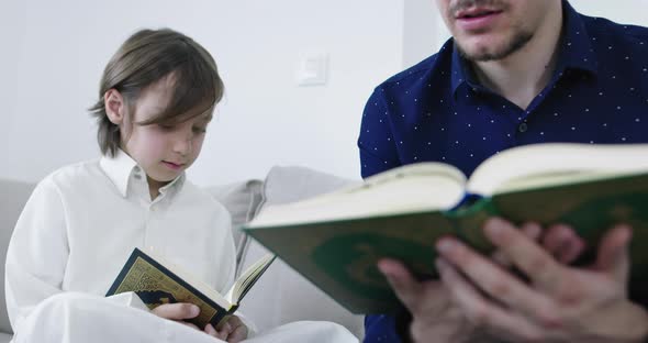 Muslim Father and Son Reading From the Quran