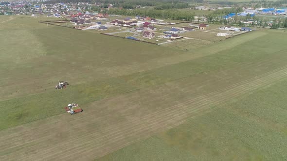 Aerial view of Combine harvesting and truck on grass field. 20
