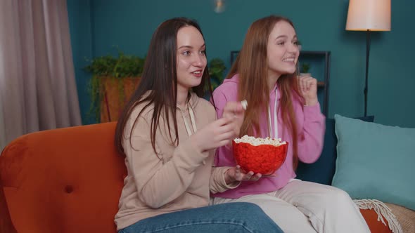 Excited Girls Friends Siblings Funs Watching Favorite Tv Sport Match Eating Popcorn at Home Sofa