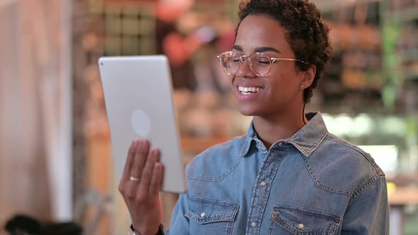 Portrait of African Woman Doing Video Call on Digital Tablet