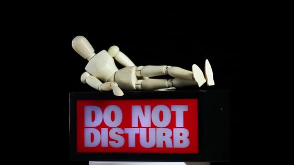 footage of wooden figure do not disturb text dark background