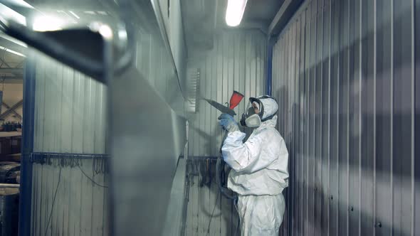 Female Worker in Protective Uniformt Dying Metal Sheets with an Air-brush