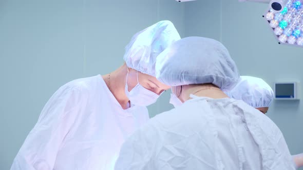 Medical Team Performing Surgical Operation in Bright Modern Operating Room