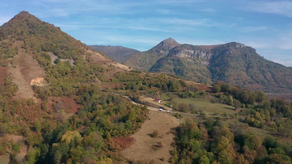 Autumn mountain with peaks, meadows and colorful forests