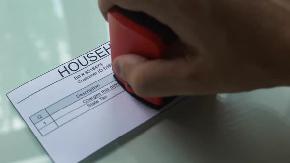 Household Bill Debt, Hand Stamping Seal on Document, Payment for Services