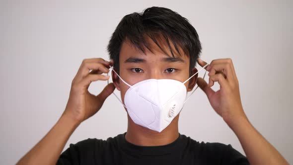Asian teen man wearing medical mask