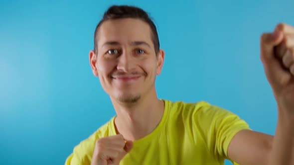 Funky Funny Smiling Man Dancing Having Fun on Blue Color Background