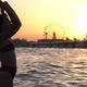 Romantic Girl Raising Her Hair Up on a River Bank at Shining Sunset in Slow Motion - VideoHive Item for Sale